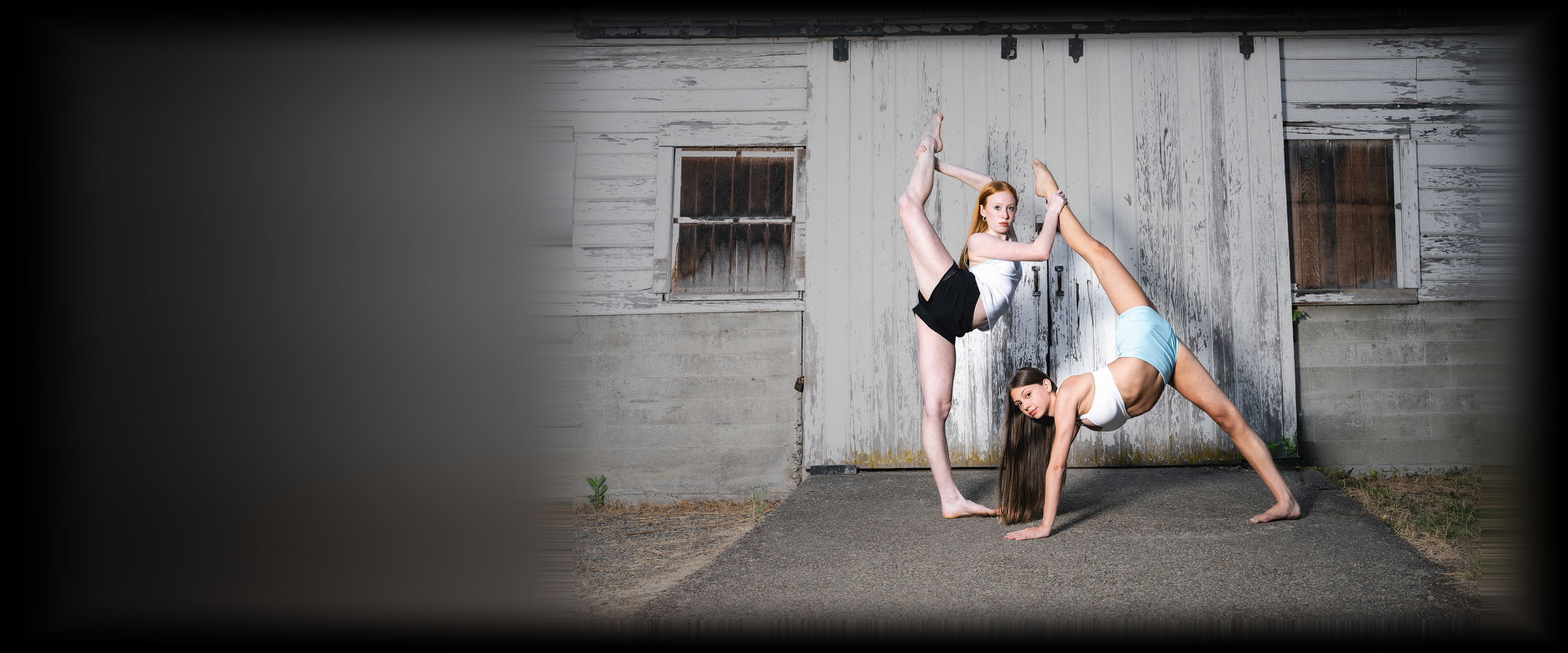 Two Elite Dance Company dancers in an acro pose